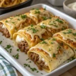 Stack of golden brown Mexican pancakes with butter melting on top and fresh strawberries on a white plate