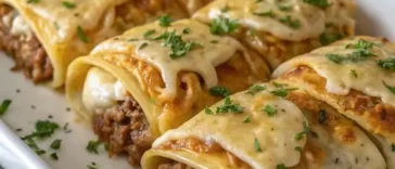 Stack of golden brown Mexican pancakes with butter melting on top and fresh strawberries on a white plate
