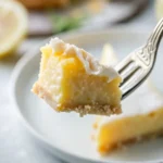 Slice of blender lemon pie on white plate with whipped cream / Lemon pie filling being poured from blender into graham cracker crust / Whole lemon pie with golden top cooling on wire rack