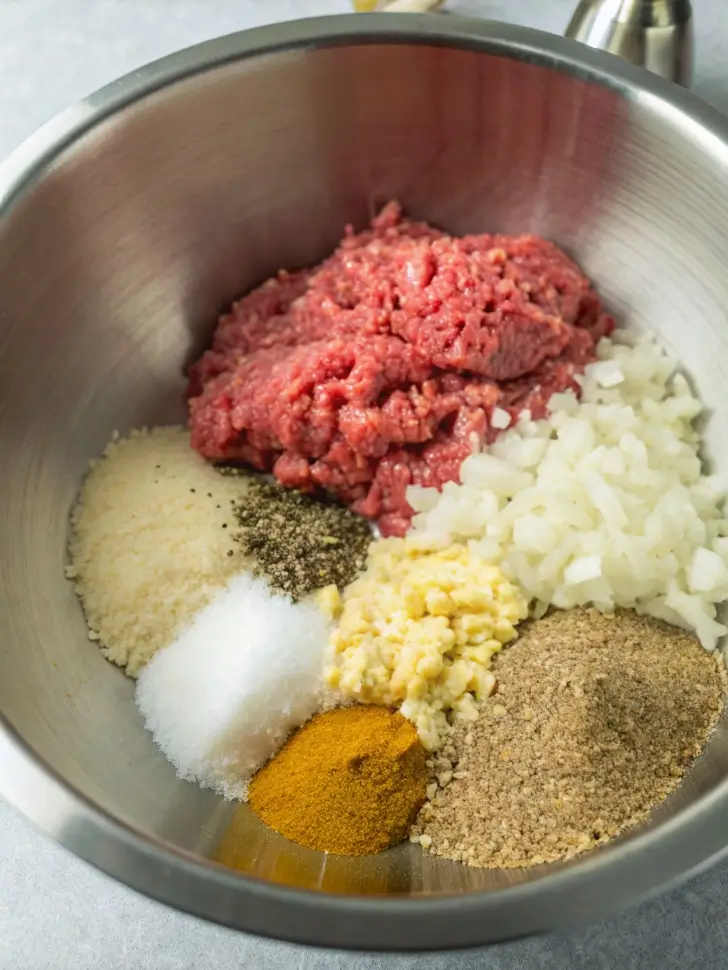 Swedish meatball noodle bake casserole in white dish with golden cheese topping and egg noodles