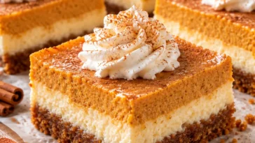 Pumpkin Cheesecake Bars with Cinnamon Cream